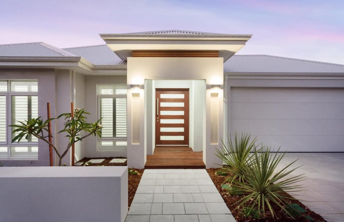Luxury custom home in Perth featuring contemporary facade with timber door, feature lighting, and native landscaping by premier Perth home builder