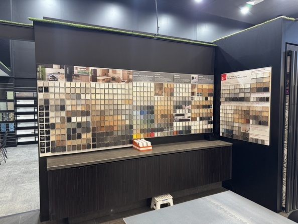 Showroom display of tile, stone, and paint colour samples at a Perth home builder, showcasing various textures and shades for home design
